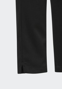 Černé kalhoty s hladkým matným povrchem, rovnou nohavicovou konstrukcí a malým rozparkem na lemu. Jednoduché prošívání dodává detail.