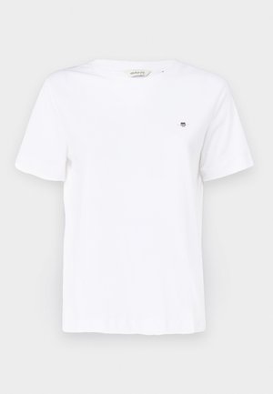 T-shirt en coton blanc à manches courtes, avec un col rond et un petit logo brodé sur la poitrine. Texture lisse et coupe classique.