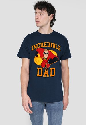 Navy blue cotton t-shirt featuring a large graphic of a superhero in a red costume with the text "INCREDIBLE DAD" in bold yellow letters.