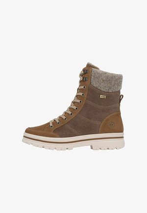 Stivale alla caviglia impermeabile marrone con tomaia in suede texturizzato e tessuto, design con lacci e suola bianca spessa. Collo alla caviglia imbottito e caldo.