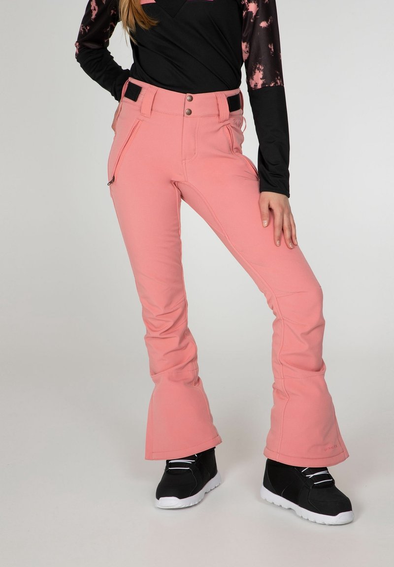 Pantalon de ski rose avec une taille ajustée, jambes évasées et poches. Confectionné dans un matériau durable avec des accents et boutons noirs. Semelles blanches sur les chaussures.