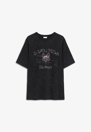 Black cotton T-shirt with a relaxed fit, featuring a graphic design of a bow and text, embellished with subtle shimmer and floral accents.