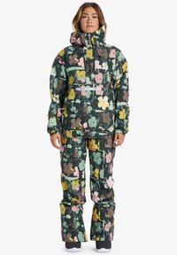 Värikasta kukkakuosisia lumipuku, jossa on vetskari edessä, huppu ja väljäntuntuiset housut, valmistettu kestävästä, vettä hylkivästä materiaalista.