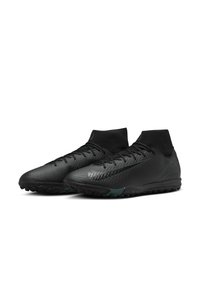 Black athletic shoes with a textured upper, high ankle design, and green accents. Features laces and a rubber sole with grip.