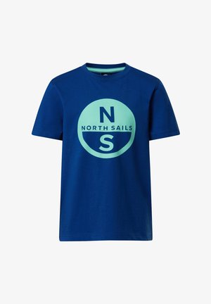 T-shirt bleu à manches courtes avec un col rond, arborant un motif de cercle bleu clair avec un "N" au-dessus du "S" et le texte "NORTH SAILS" au centre.