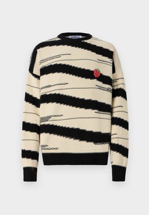 Beige sweater with black zigzag stripes and a small red strawberry applique. Ribbed neckline and cuffs. Knit texture, relaxed fit.