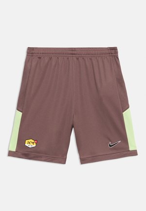 Brune treningsshorts med lysegrønne sidepaneler, elastisk midjebånd, Nike-swoosh på høyre ben og heksagonalt "KM Air"-logo på venstre ben.