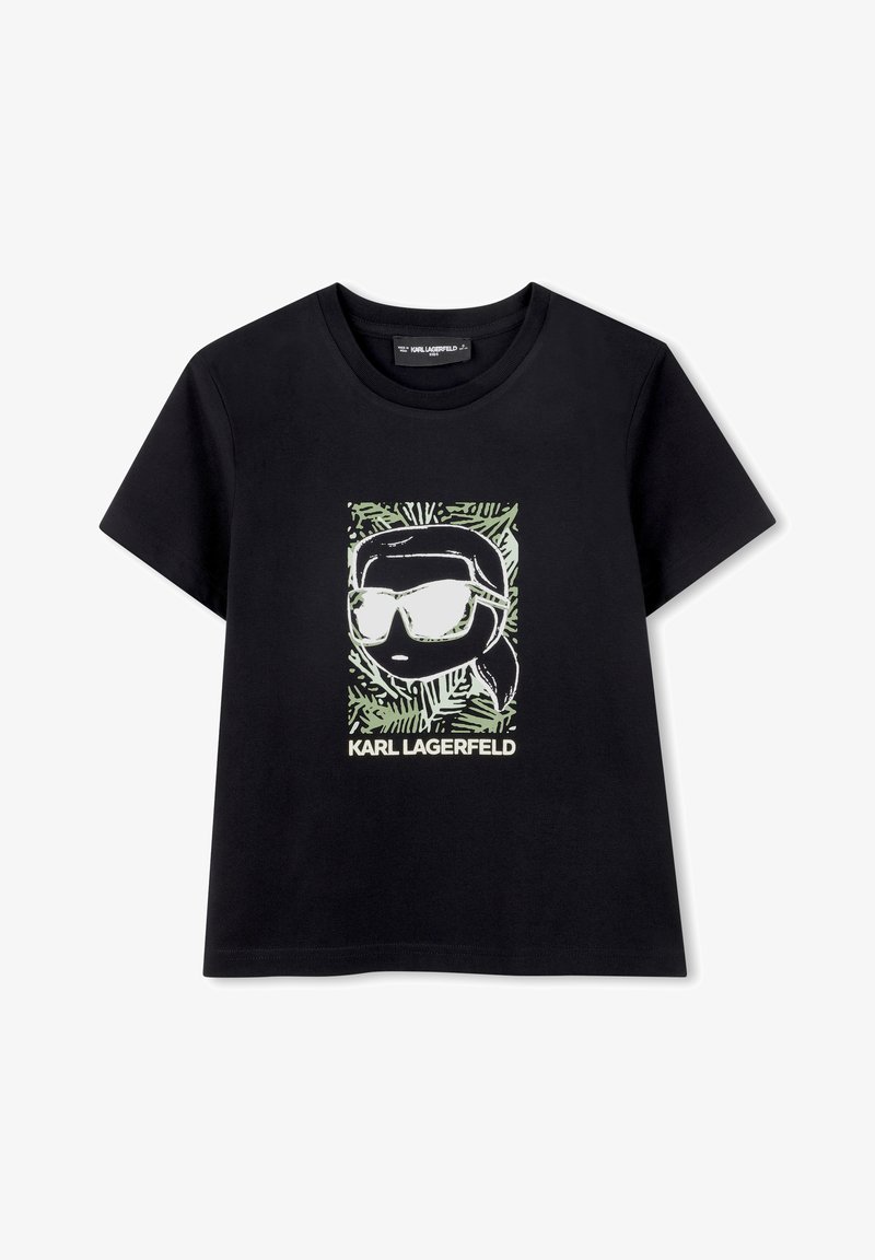T-shirt en coton noir avec un imprimé graphique représentant une personne portant des lunettes de soleil, encadrée par des motifs verts, avec le texte "KARL LAGERFELD" en bas.