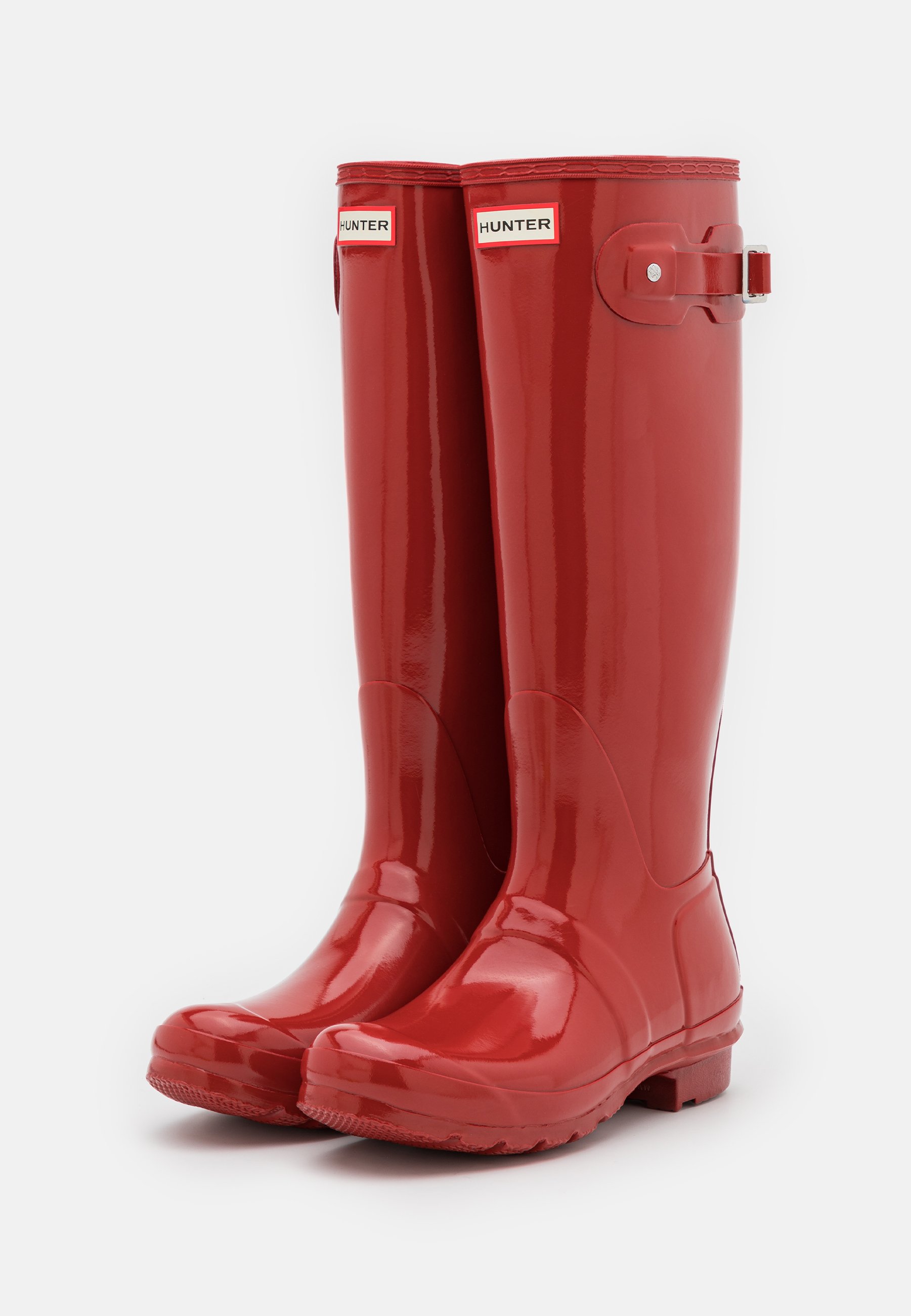 Rdeče vodoodporne gumijaste škornje za dež, sijoča površina, do kolen, z zaponko in teksturirano podplati za dober oprijem.