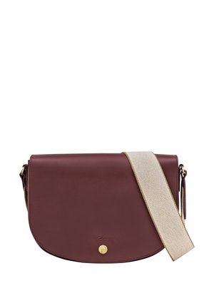 Burgundy leather crossbody bag with a rounded flap. Features a gold snap closure and a textured beige strap. Smooth surface with minimal detailing.