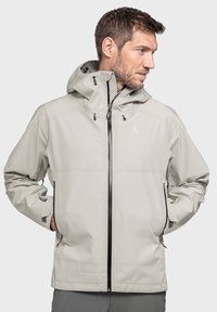 Helle graue wasserdichte Jacke mit Kapuze, Frontreißverschluss, seitlichen Taschen und schwarzen Reißverschlussakzenten. Glatte Textur und moderner Schnitt.