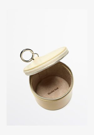Round beige leather keychain case with a silver zipper and ring, branded "Massimo Dutti" inside, displayed open on a white background.