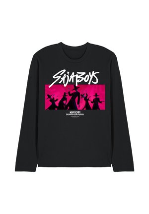 Black long-sleeve shirt with white "SAJABOYS" text above silhouettes of five figures in hats against a bright pink background, "KPOP DEMON HUNTERS" below.