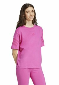Pink cotton t-shirt featuring short sleeves, round neckline, and three diagonal stripes on each sleeve. Subtle logo on the chest.
