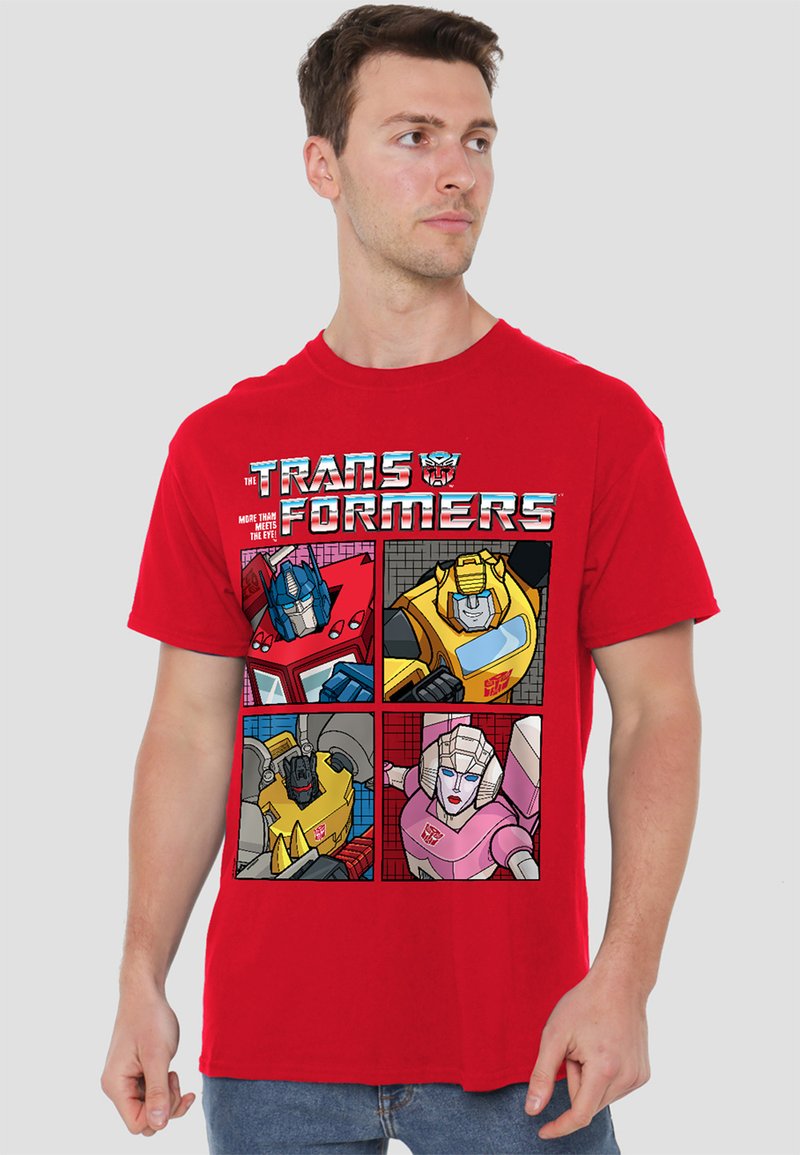 Red cotton t-shirt featuring a graphic with four Transformers characters in comic-style panels; includes vibrant colors and outlined details.