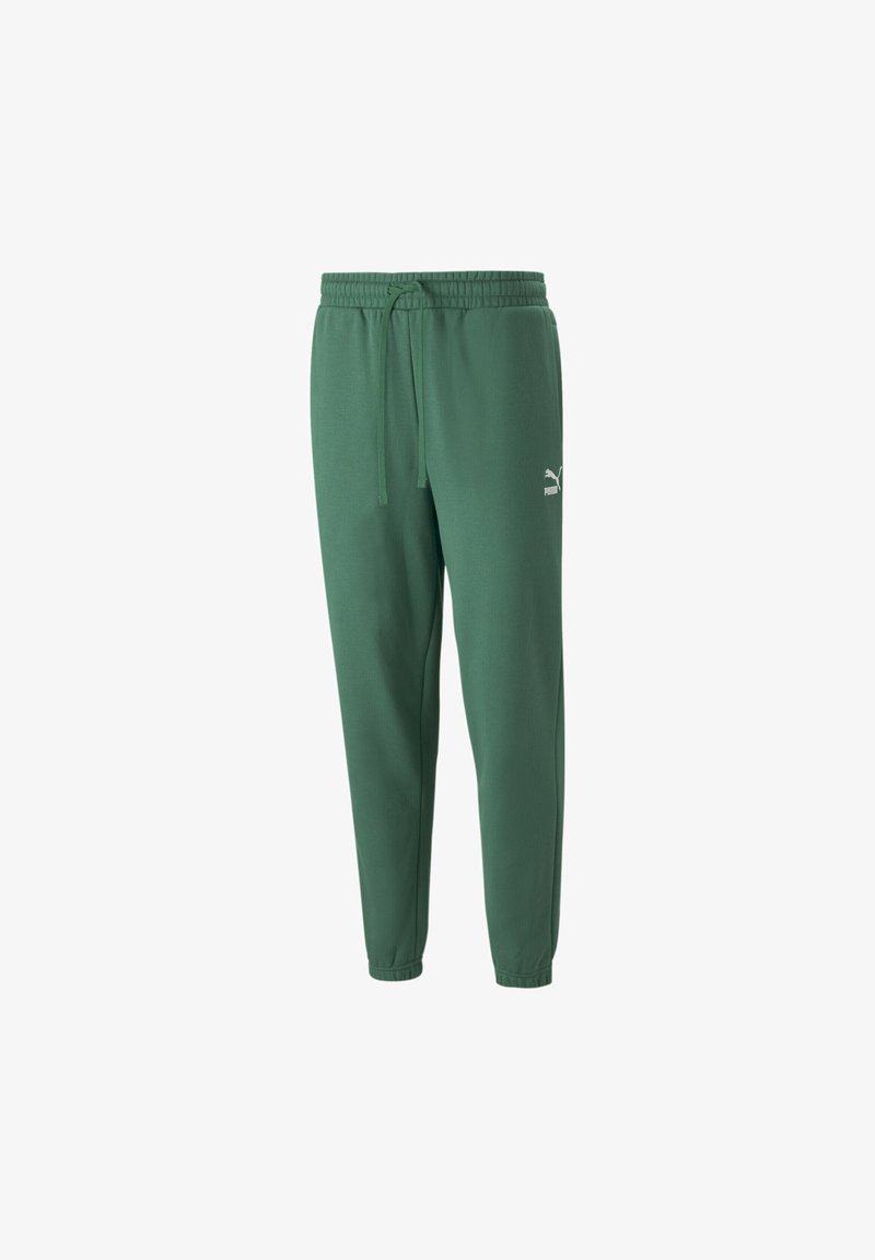 Groene sportieve joggers van zacht materiaal met een trekkoord in de taille en elastische enkelboorden; heeft een klein wit logo aan de linkerkant.