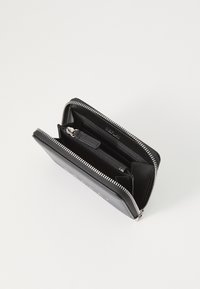 Black leather wallet with a zip closure, featuring multiple compartments and a smooth texture. Silver hardware and stitching details are visible.