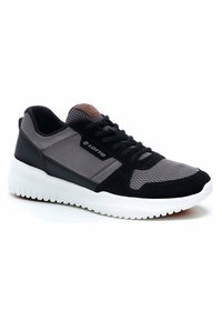Black and gray athletic shoe featuring a mesh upper, suede accents, padded collar, and a white rubber sole with textured grip.