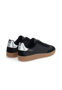 Black suede and textile sneakers with silver accents on the heel, featuring a gum rubber sole and black laces.