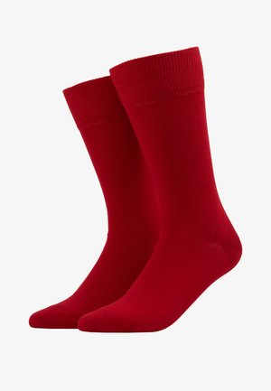 Red cotton socks with ribbed cuffs, featuring a smooth texture and rounded toe design. Suitable for casual wear.