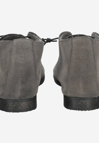 Bottines en suède gris avec un bout arrondi, des lacets décoratifs et un petit talon noir. "Carolina" est embossé à l'arrière.