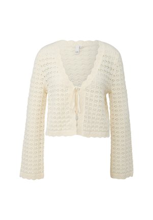 Cremekleurige gehaakte cardigan met geschulpte randen, lange mouwen, V-hals en vooraan met een strik sluiting.