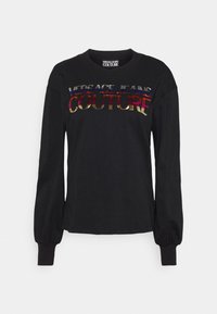 Sort langærmet skjorte med puffede manchetter og flerfarvet "VERSACE JEANS COUTURE"-logo på tværs af brystet.