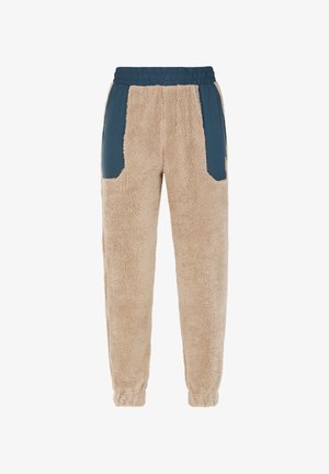 Pantalones joggers de forro polar beige con paneles laterales de nylon azul y cinturilla elástica. Presenta bolsillos con parche y puños elásticos en los tobillos.