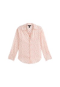 Lange mouwen blouse in lichtroze stof met rode stippen. Beschikt over een kraag en knoopsluiting aan de voorkant, met een ronde zoom.