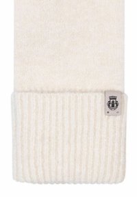 Strickmütze in Creme mit einem gerippten Bündchen. Mit einem Stoffetikett mit einem Emblem. Weiche Textur, gleichmäßige Farbe durchgehend.