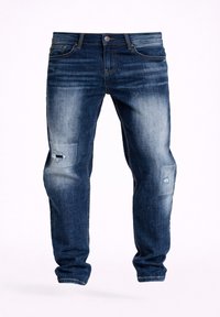 Vaqueros de mezclilla azul oscuro descoloridos con un ajuste slim, que presentan un ligero desgaste y pequeñas roturas en los muslos y las rodillas.