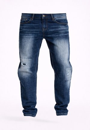 Tmavě modré vybledlé džíny z denimu s úzkým střihem, s lehkým opotřebením a malými trhlinami na stehnech a kolenou.