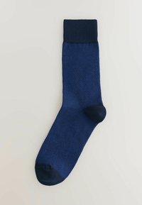 Mid-calf dark blue sock with a subtle textured pattern, featuring solid navy cuff, heel, and toe sections.