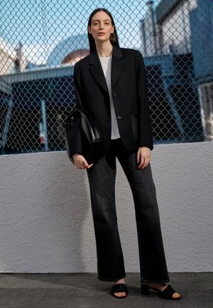 NEW ALEXXIS HIGHRISE WIDE - Flared jeans - black