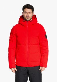 Red puffer jacket with a hood, featuring a zip closure and side pockets. Constructed from durable, water-resistant material.