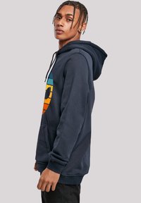 Navy blue hoodie made of cotton blend, featuring a large multicolored graphic design on the front, kangaroo pocket, and drawstring hood.