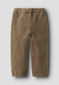 Brūni korduroja bikses ar brīvu piegriezumu. Elastīga josta, īss garums un smalkas šuves detaļas uz kājām.