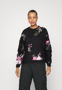 Black sweatshirt with multicolored floral patterns in pink and white, featuring a crew neckline and ribbed cuff detailing.