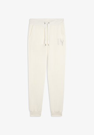 Pantalones de chándal color crema, hechos de un tejido suave, con una cinturilla elástica con cordones, bolsillos laterales y un acento de logo plateado.