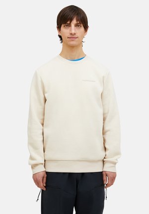 Cremefarvet sweatshirt lavet af blødt stof, med rund halsudskæring, ribbede manchetter og et diskret "Peak Performance" logo foran.