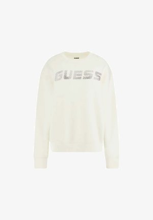 Light cream sweatshirt with long sleeves, featuring a textured silver "GUESS" logo across the front. Simple crew neckline, relaxed fit.