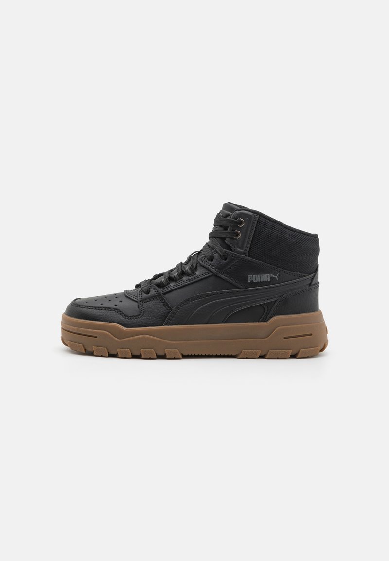 Black high-top sneakers made of leather and fabric, featuring a round toe, lacing system, and a brown rubber sole with textured grip patterns.