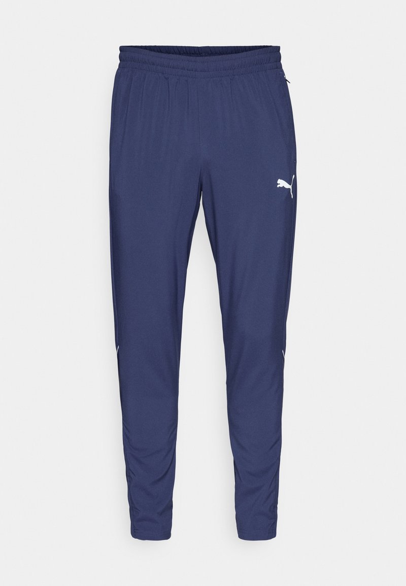 Pantalones deportivos azul marino con cintura elástica, piernas ajustadas, bolsillos laterales y logo blanco de Puma en el muslo derecho.