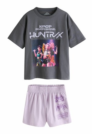 Dark gray short-sleeve shirt with KPOP Demon Hunters Huntrx text and three animated female characters, paired with light purple elastic-waist shorts.