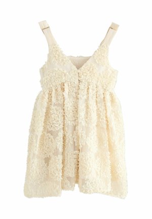 Flower-embellished dress in cream, featuring a V-neck, adjustable straps, and a relaxed silhouette with a gathered waist and lightweight fabric.