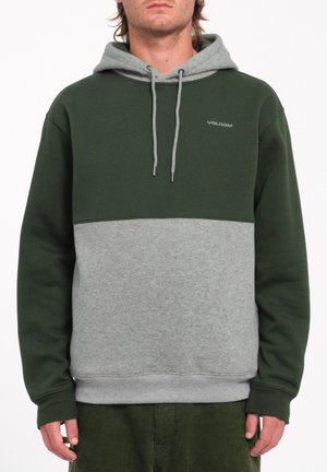 Haut à capuche vert et gris, avec une poche kangourou, un cordon de serrage à capuche et des poignets côtelés. Fabriqué en tissu doux et texturé en mélange de coton.
