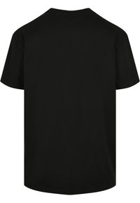 T-shirt en coton noir à manches courtes, décolletée ronde et coupe droite. Texture douce sans logos ni motifs visibles.