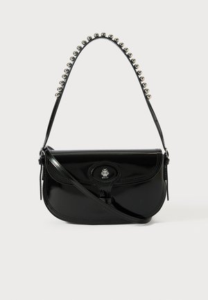 Black patent leather handbag with a curved shape. Features a metallic bead-accented strap and a branded oval clasp. Smooth texture.