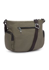 Olive green crossbody bag made of nylon. Features a main zip compartment, front zip pocket, and side pockets. Adjustable strap included.