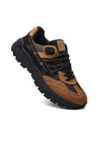 Sneaker marrone con dettagli neri, pannelli in rete, pelle testurizzata e suola spessa. Presenta lacci scuri e una linguetta con logo.